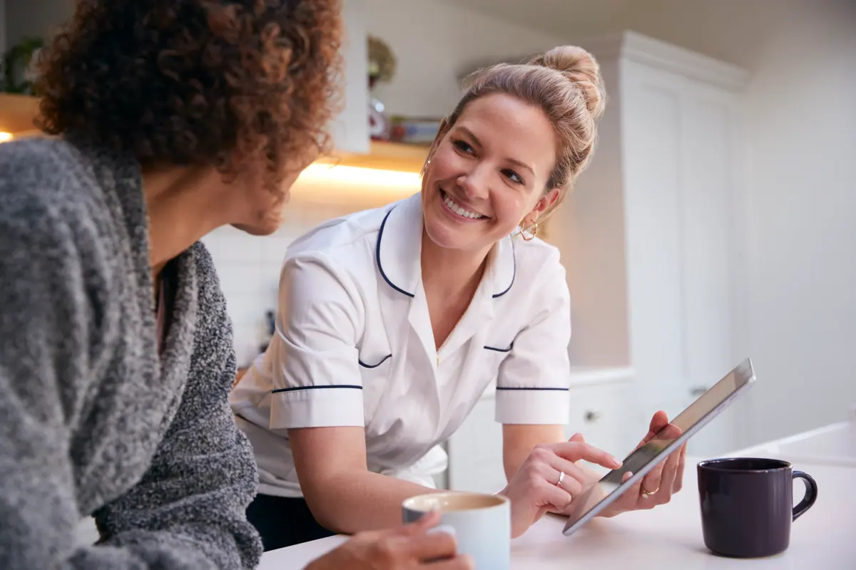 Local care professional speaking with a client at home